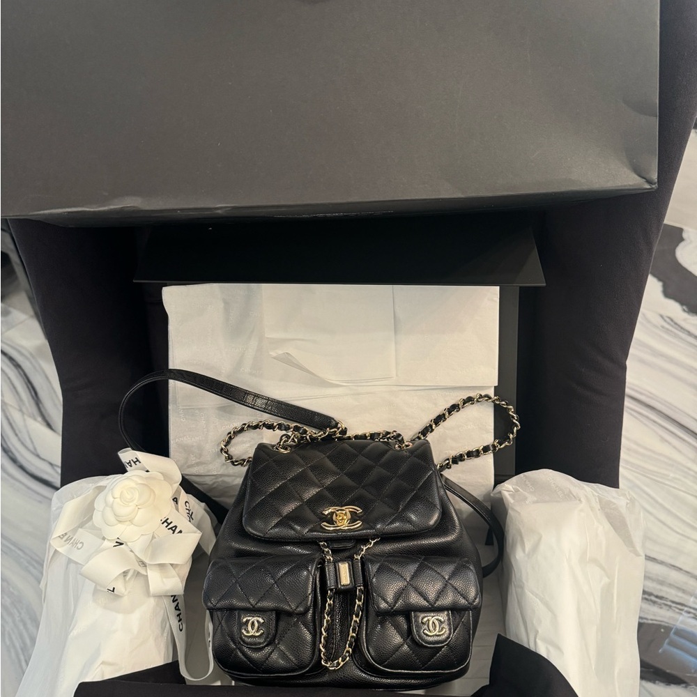 CHANEL Black Quilted Backpack with Gold Accents